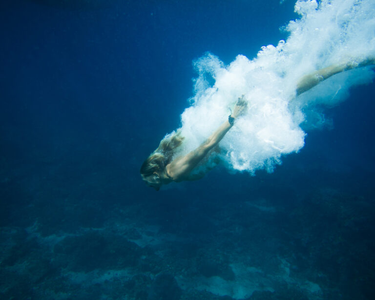 underwater pic of young man diving in ocean alone