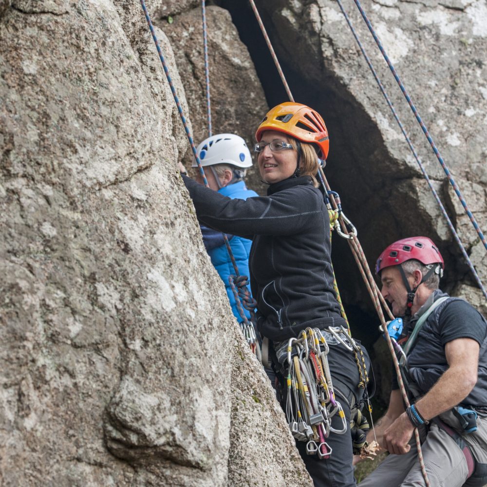 Climbers ascending a rugged mountainside