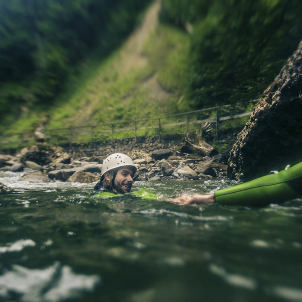 Germany, Bavaria, Allgaeu, young couple canyoning in Ostertal