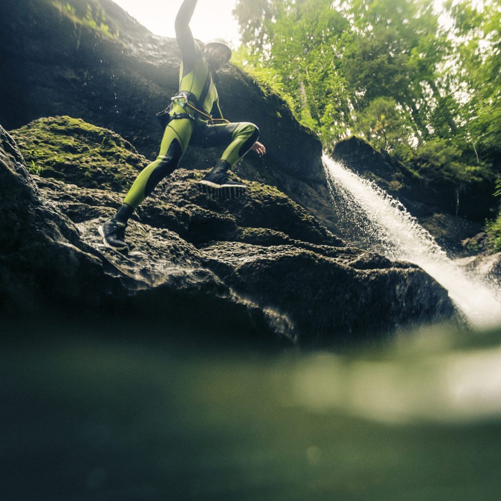 Germany, Bavaria, Allgaeu, young man canyoning in Ostertal