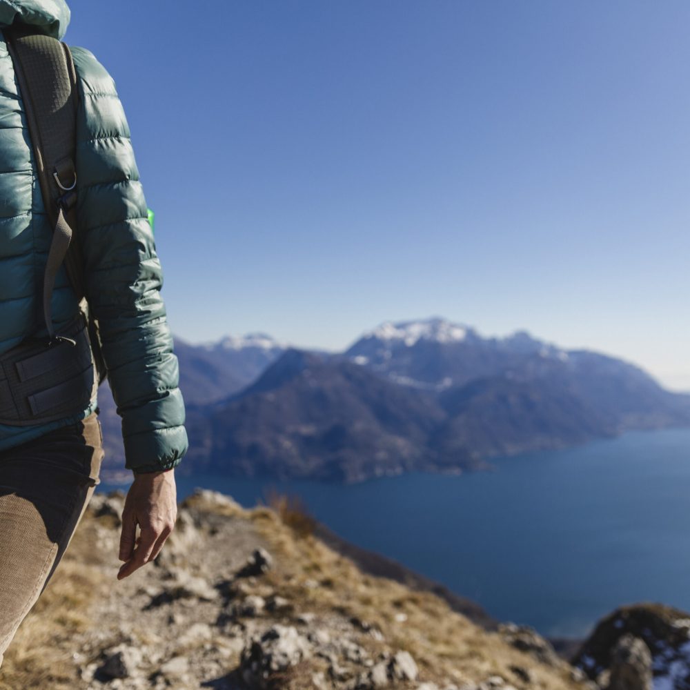 Italy, Como, Lecco, woman on a hiking trip in the mountains above Lake Como