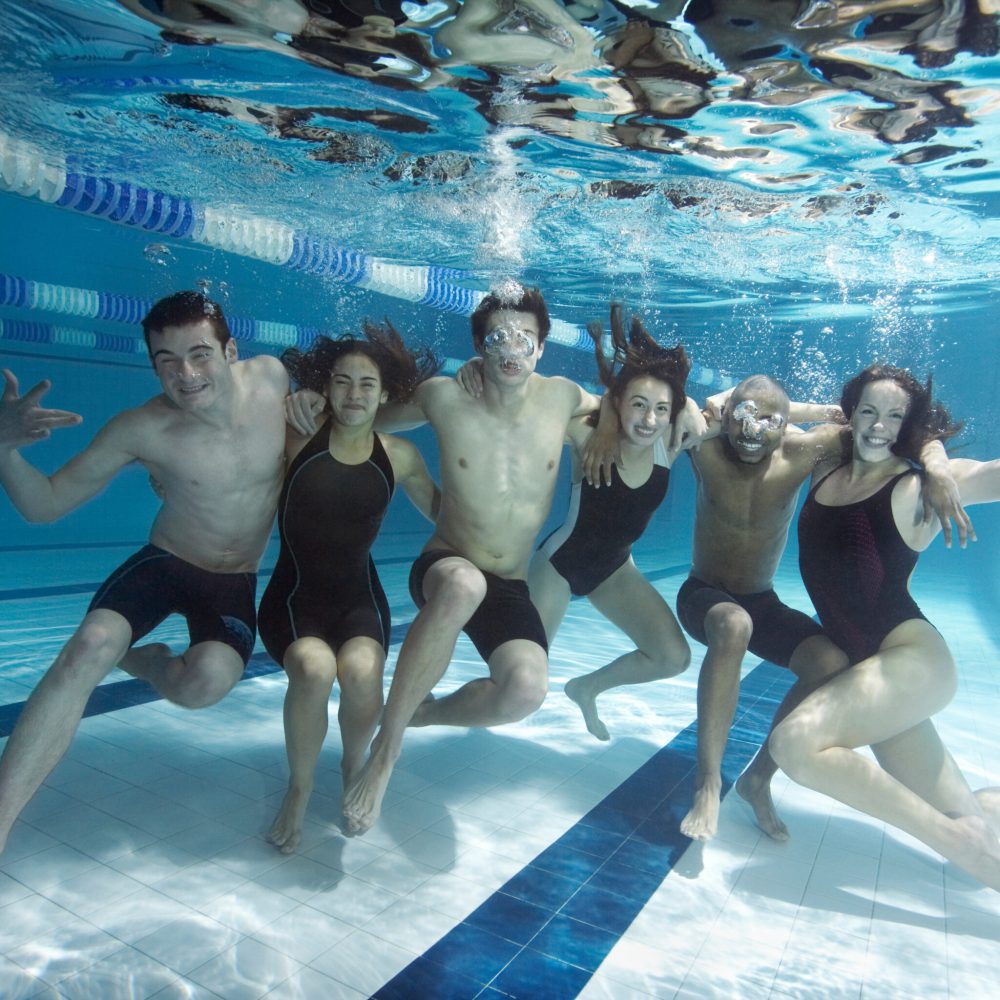 Swimmers posing underwater together