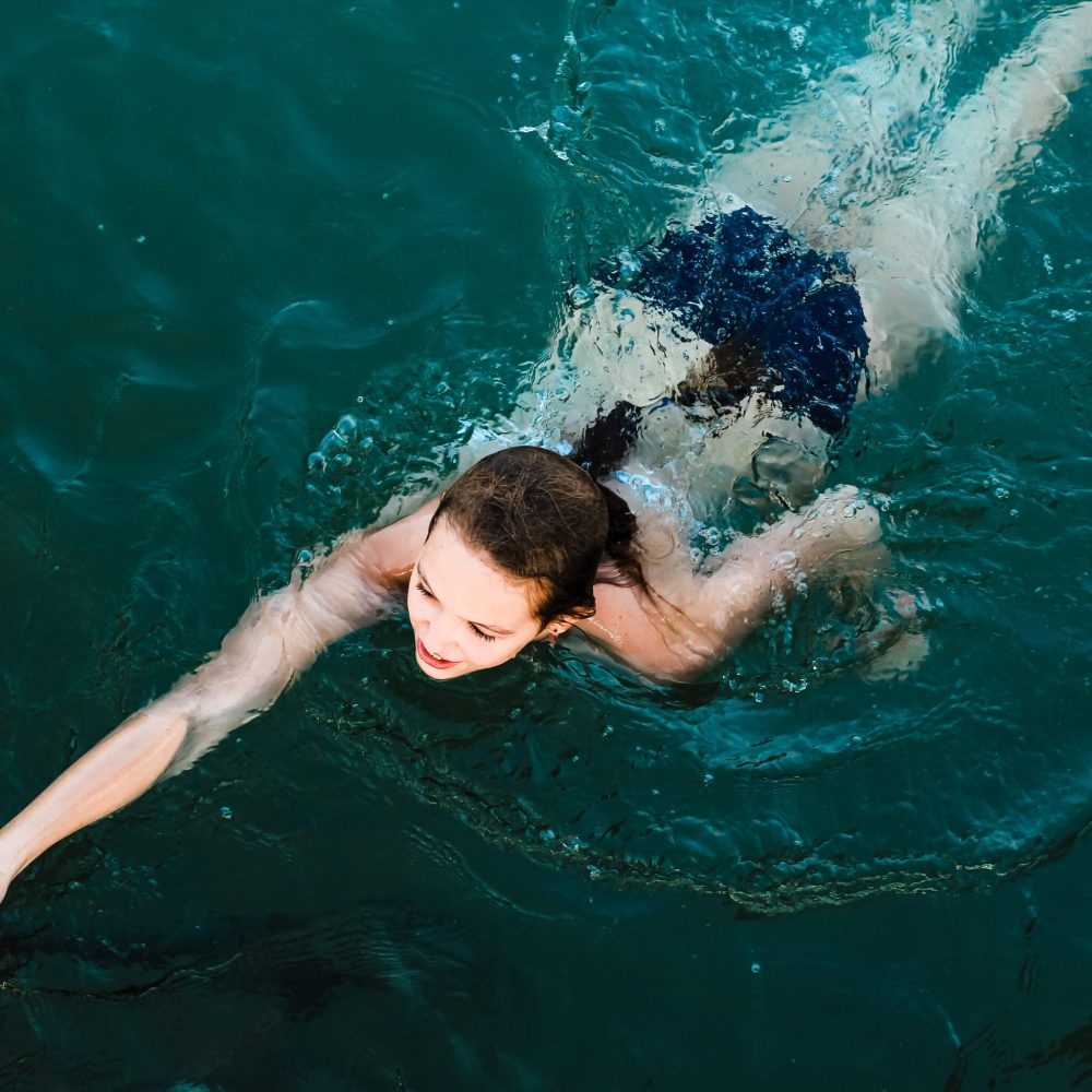 teenage-girl-swimming-in-the-sea-summertime-outd-2024-12-04-17-17-27-utc