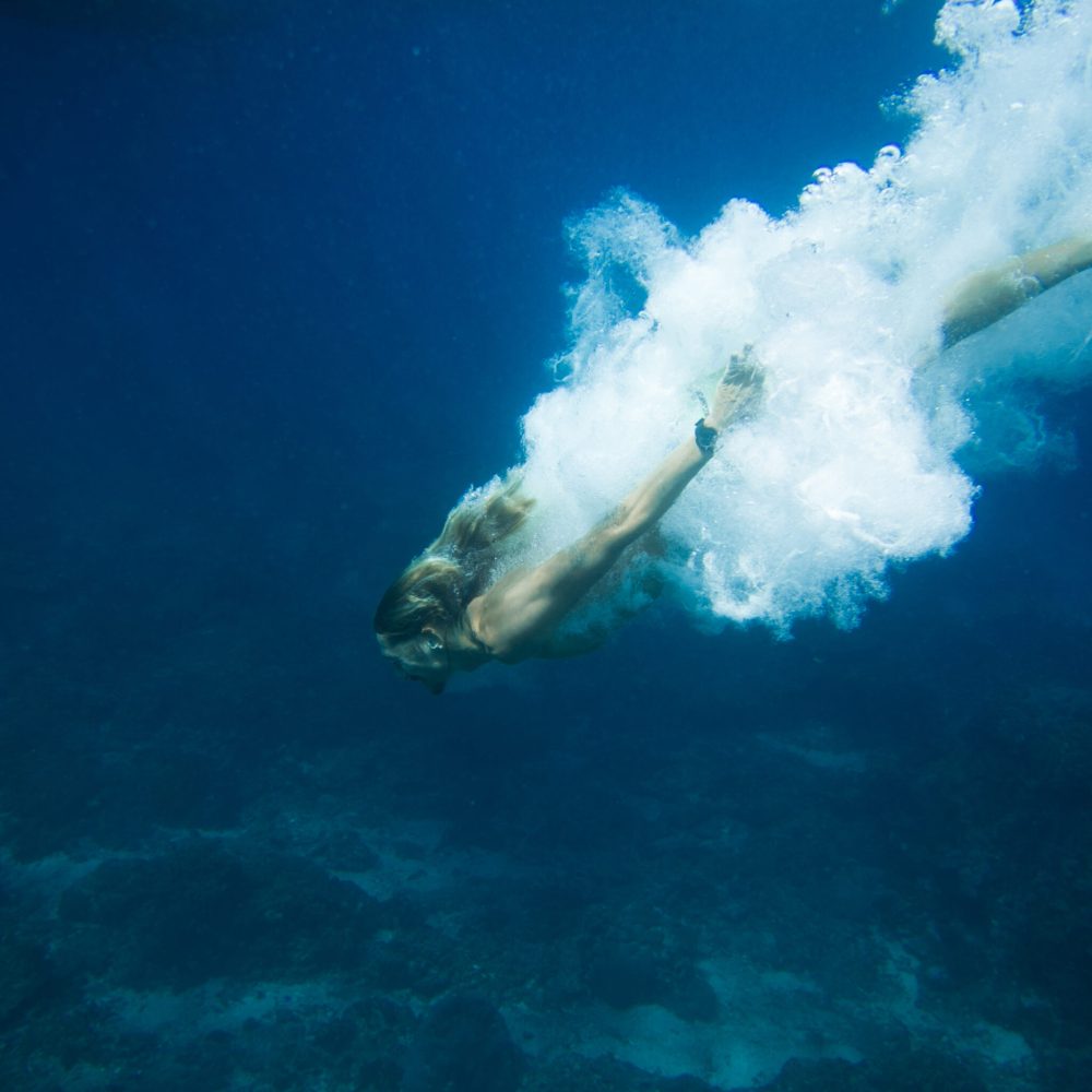 underwater pic of young man diving in ocean alone