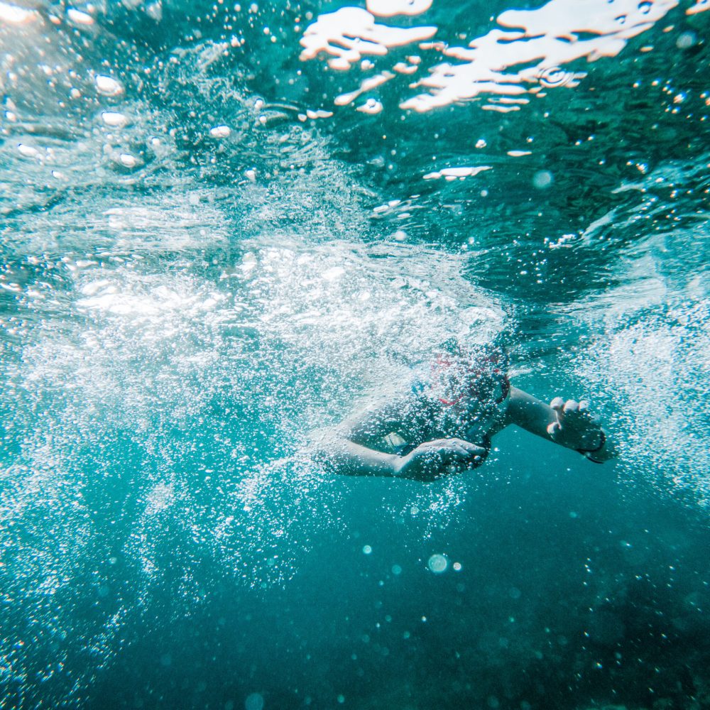 woman snorkeling in clear tropical sea