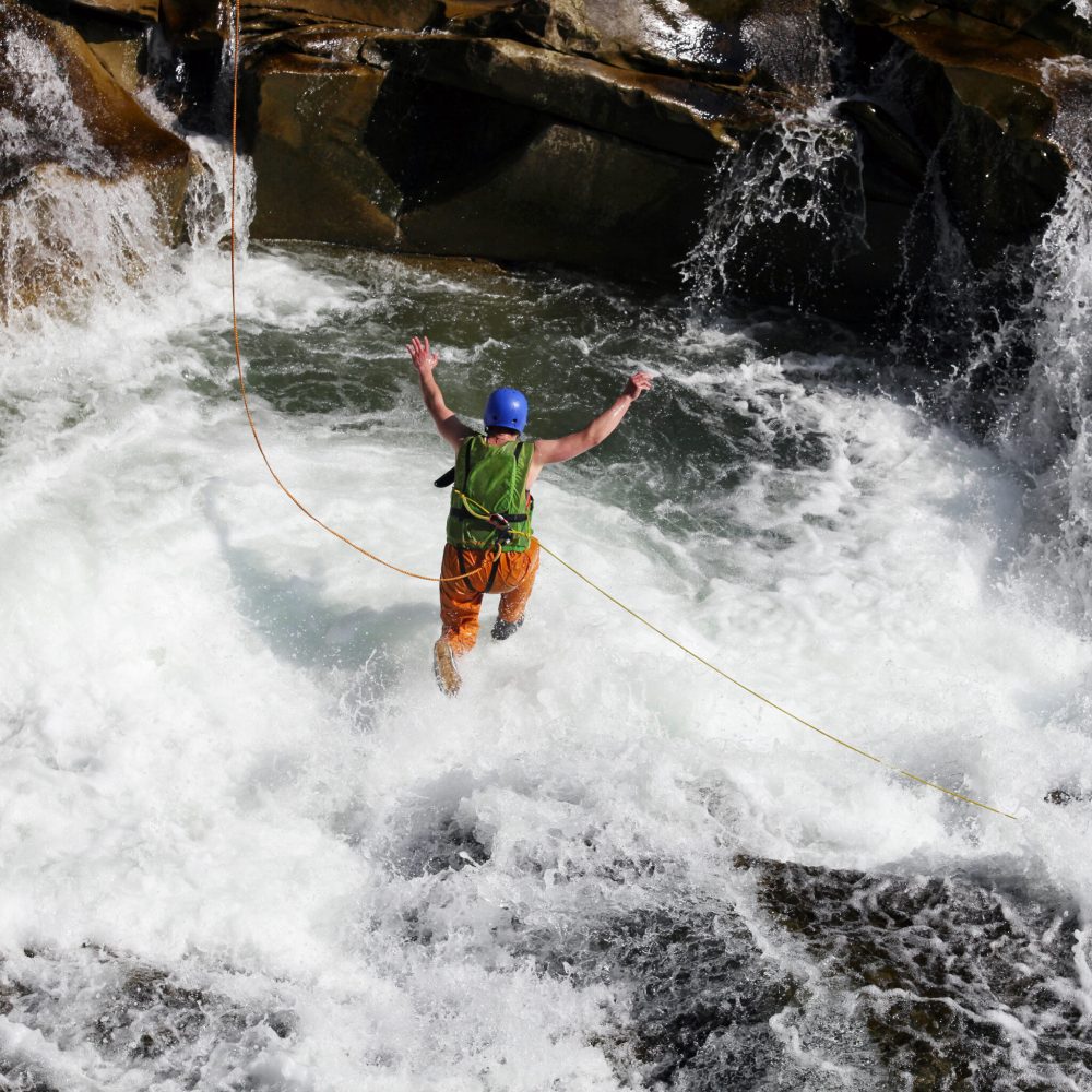 young-man-rope-jumping-in-rapid-waters-of-a-river-2025-01-09-02-23-18-utc